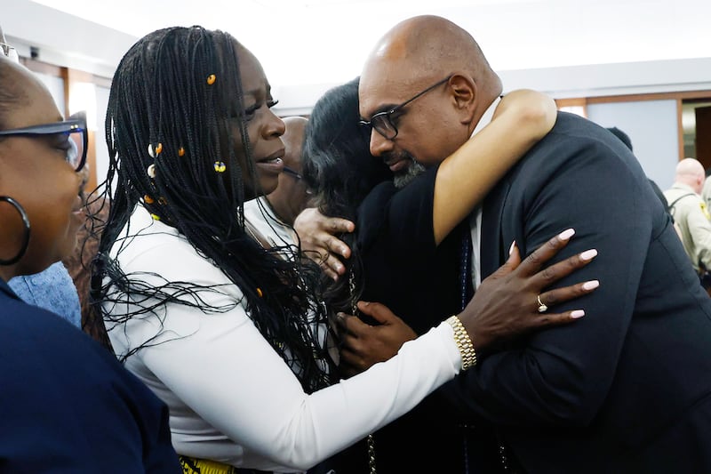 Friends and family members of rapper Tupac Shakur, including his sister Sekyiwa Shakur, second left, line up to hug prosecutor Binu Palal. Photogrpah: Bizuayehu Tesfaye/Las Vegas Review-Journal via AP