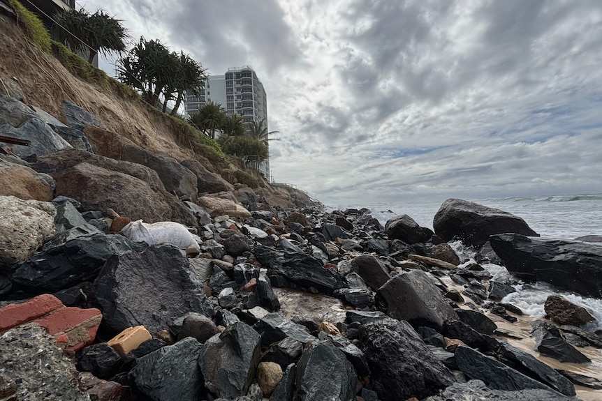 A rocky wall where beach sand dunes used to stand