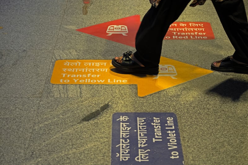 Floor stickers guide passengers in the New Delhi metro system. Photograph: Karan Deep Singh/The New York Times
                      