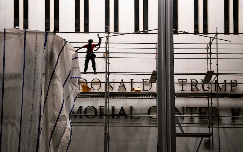 Workers prepare to remove Donald Trump’s name from the facade of the John F Kennedy Center for the Performing Arts in Washington in June.  Photograph: Pete Kiehart/New York Times
                      
