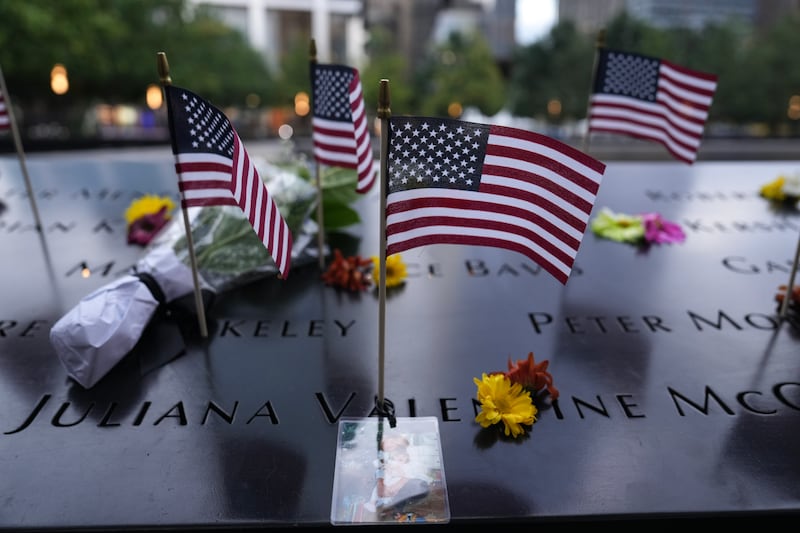 NEW YORK, NEW YORK - SEPTEMBER 11: Flowers and American flags are seen at the memorial ahead of a memorial ceremony to commemorate the 25th anniversary of the September 11th terrorist attacks on the World Trade Center at the National 9/11 Memorial & Museum on September 11, 2026, in New York City. The United States is marking the 25th anniversary of the terrorist attacks of September 11, 2001, when a group of al-Qaeda hijackers flew airplanes into the World Trade Center, Shanksville, Pennsylvania, and the Pentagon, killing nearly 3,000 people. (Photo by David Dee Delgado - Pool/Getty Images)