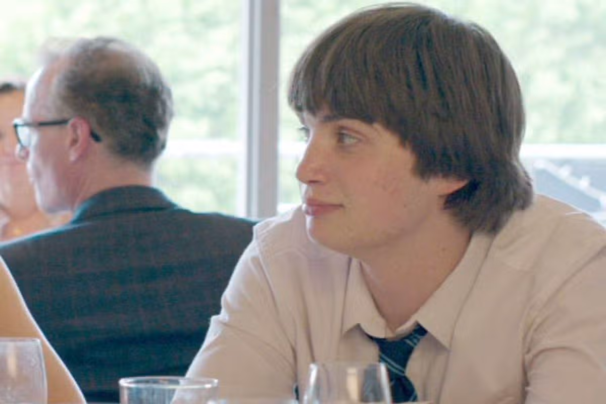 A woman and a boy look at each other at a table