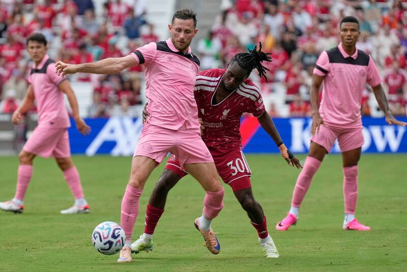 Sunderland midfielder Alan Browne, left, and Liverpool FC defender Jeremie Frimpong battle for the ball. Pic: AP Photo/George Walker IV
