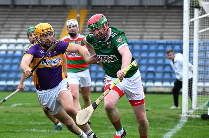 Tracton goalkeeper Seán O'Sullivan battles to make a clearance under pressure from Eoin Condon of St Catherine's. Picture: Larry Cummins