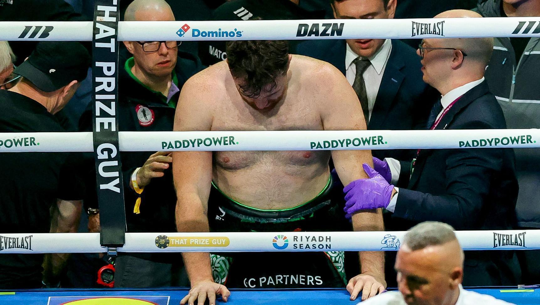 Thomas Carty rises to his feet after falling out of the ring. Piic INPHO/Ben Brady