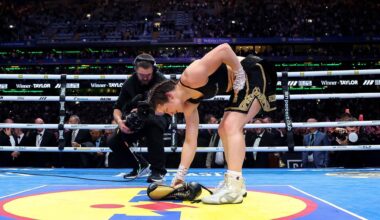 LAYING A GLOVE: Katie Taylor lays her boxing gloves on the canvas for the final time to signify her retirement after victory Saturday night at Croke Park. Pic: Gary Carr, Inpho