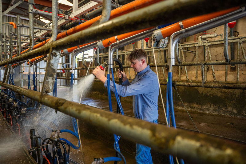 Farmer Peter Thompson hoses down his new milking parlour at his farm in Aghamarta, Carrigaline, Co. Cork. Picture: Noel Sweeney.