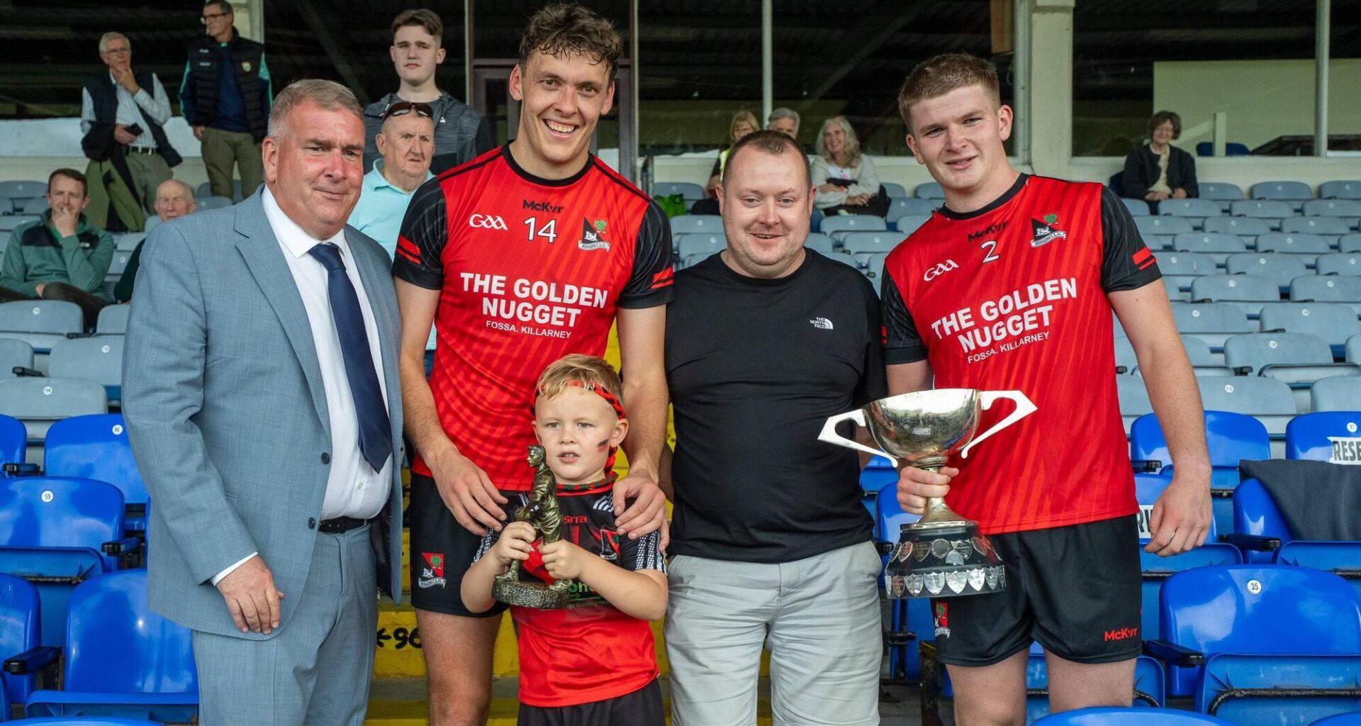From left: Patrick O’Sullivan, Chairman of Kerry GAA, Man of the Match David Clifford with his son Ogie, Mike Tagney of Kerry Petroleum and Fossa captain Sam Buckley with the cup following their victory over Kilcummin in the Kerry Petroleum Intermediate Club Football Championship final at Fitzgerald Stadium on Sunday. Photo: Tatyana McGough.