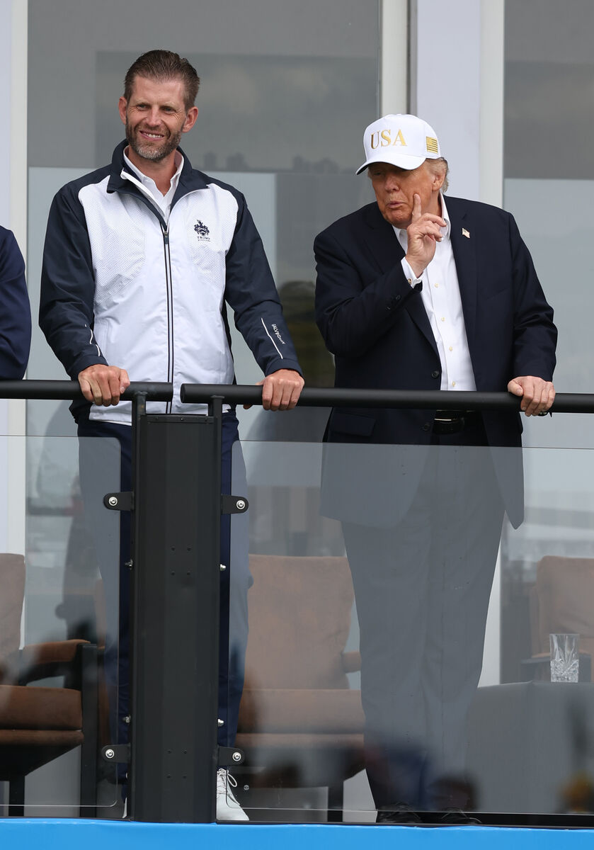 Donald Trump and his son Eric watch the golf last weekend.