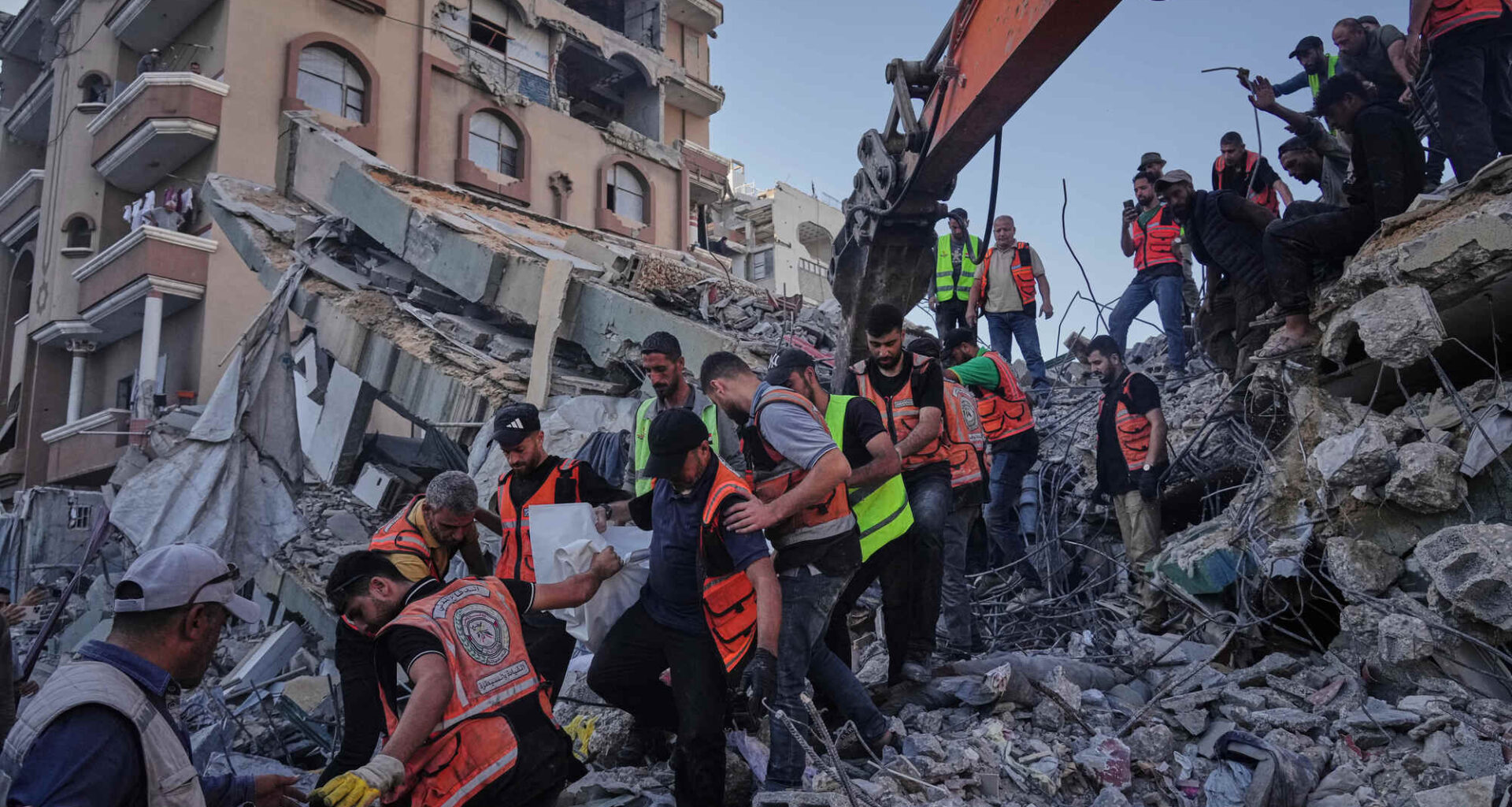 Palestinian civil defence crews carrying a body from the rubble of a collapsed building in Gaza last Wednesday. It had housed displaced Palestinians but was damaged by recent Israeli missile attacks. Picture: Jehad Alshrafi/AP