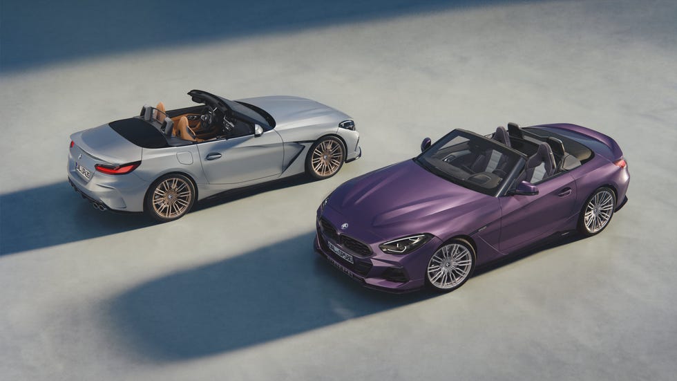 Two luxury convertible sports cars in silver and purple against a light background. Two luxury convertible sports cars in silver and purple against a light background.