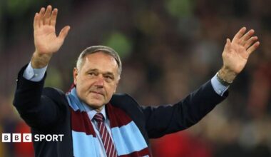 Ludek Miklosko, wearing a West Ham scarf, waves