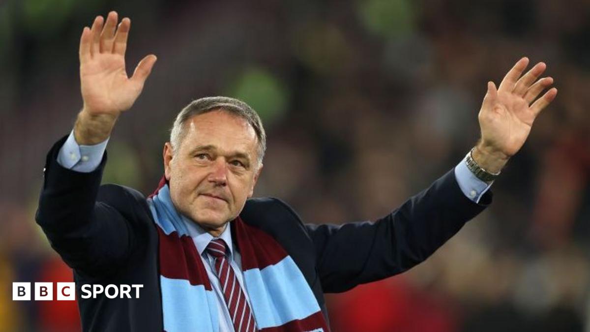 Ludek Miklosko, wearing a West Ham scarf, waves