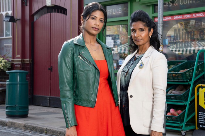 572170,TITLE:Eastenders Ash and Suki pose outside of the Minute Mart in EastEnders