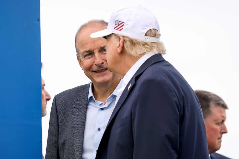 Micheál Martin stands on the first tee box with Donald Trump. Photograph: Ben Brady/Inpho
