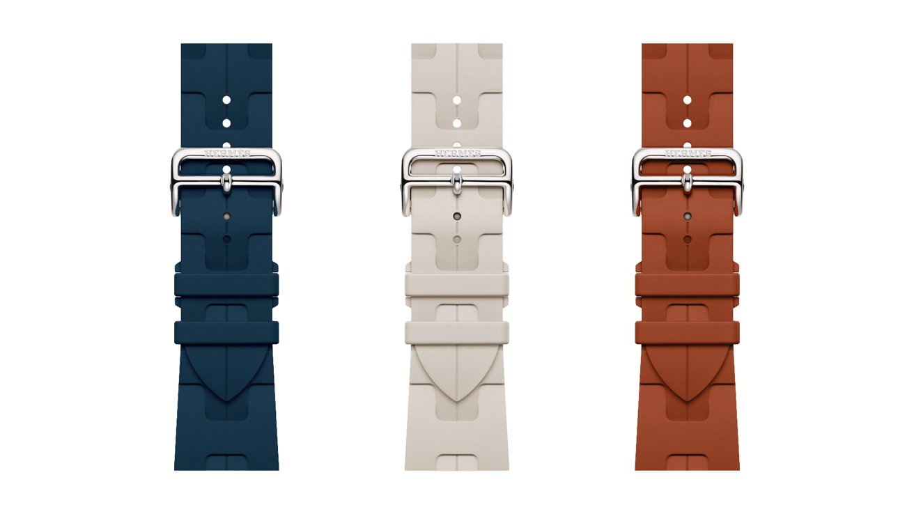 Three rubber watch straps in navy blue, light beige, and rust brown, each with a silver buckle, displayed vertically side by side on a plain white background.