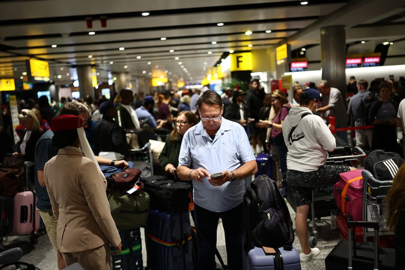 Delayed passengers waiting with their luggage in Terminal 3 of London Heathrow Airport on Tuesday evening as a result of an air traffic control issue. Photograph: Henry Nicholls/AFP via Getty Images