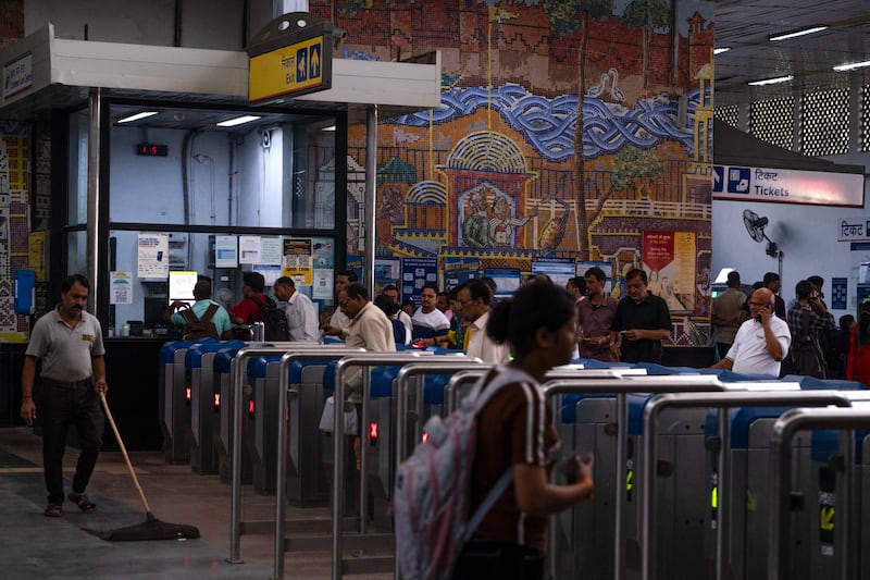 Passengers navigate fare gates at a subway station entrance in New Delhi. Photograph: Karan Deep Singh/The New York Times
                      