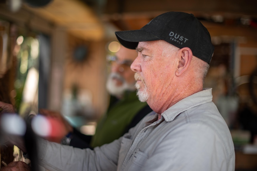 A man concentrates on working.