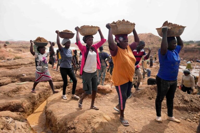 Women work at an Illegal tin mining site in Jos, Nigeria, Wednesday, April 3, 2024. The recent arrests come as Nigeria seeks to regulate mining of critical minerals, curb illegal activity and better benefit from its mineral resources. Image by AP Photo/Sunday Alamba.