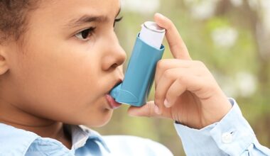 child holding asthma inhaler