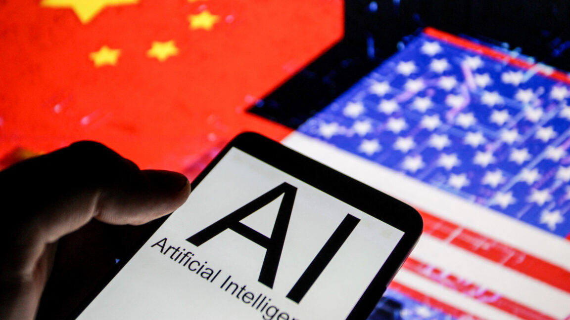 Close up view of a smartphone displaying the words AI Artificial Intelligence in front of blurred flags of the United States and China illustrating technological competition between the two countries.