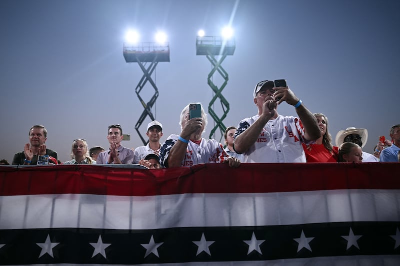 Supporters take pictures as Donald Trump speaks at a rally at Gastonia Municipal Airport in Gastonia, North Carolina, as he campaigns for Senate candidate Michael Whatley. Photograph; Brendan Smialowski/AFP via Getty Images