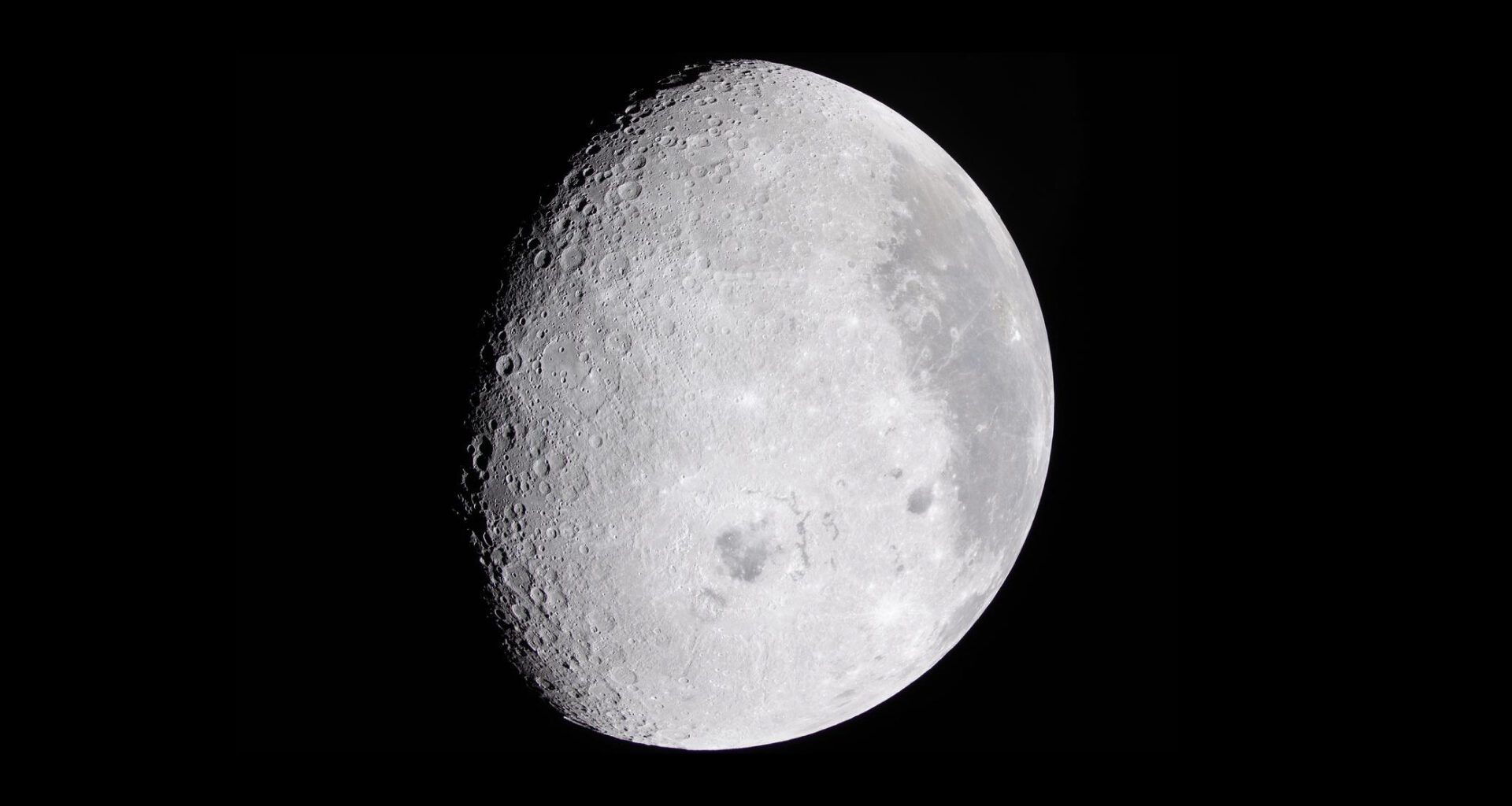 The moon in a black sky.