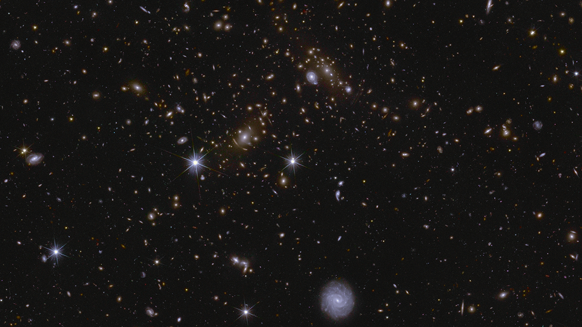 Euclid’s Deep Field South, zoomed in, shows numerous huge galaxy clusters and gravitational lenses. The central cluster is J041110.98-481939.3, located almost 6 billion lightyears away. Credit: ESA/Euclid/Euclid Consortium/NASA, image processing by J.-C. Cuillandre, E. Bertin, G. Anselmi