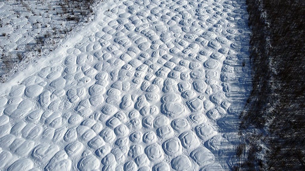 Aerial image showing a bumpy landscape caused by melting permafrost in eastern Siberia.
