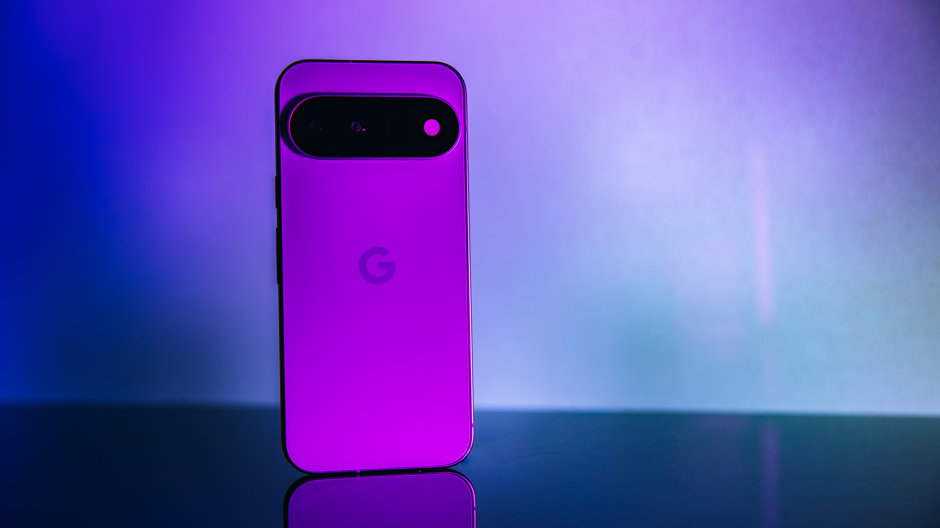 The back of the Pixel 11 illuminated by a purple light