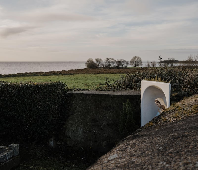 A makeshift shelter for a statue of the Virgin Mary overlooking the lough from the graveyard where the High Cross of Ardboe is situated. Photograph: Joe Laverty