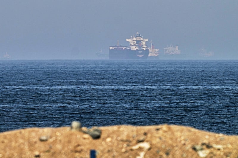 Cargo ships are seen at sea near the Strait of Hormuz (AP)
