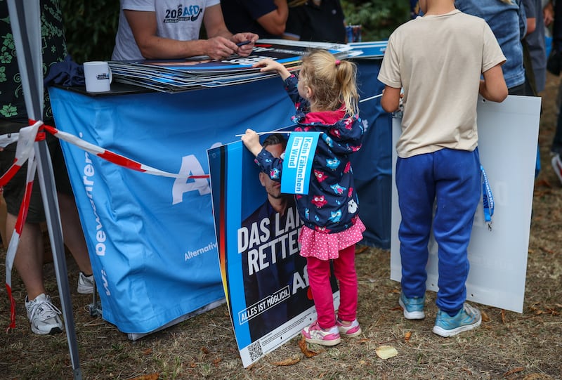 A young girl at an AfD campaign event in Haldensleben, eastern Germany. Photograph: Ronny Hartmann/AFP/Getty Images