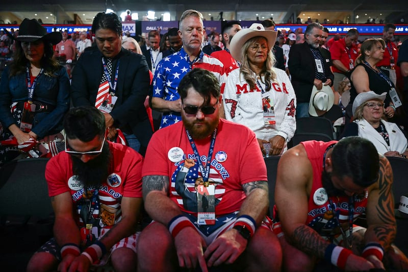 Attendees bow their heads during prayer on the first day of the Republican National Midterm Convention at the American Airlines Center in Dallas, Texas. Photograph: Kent NISHIMURA/AFP via Getty Images