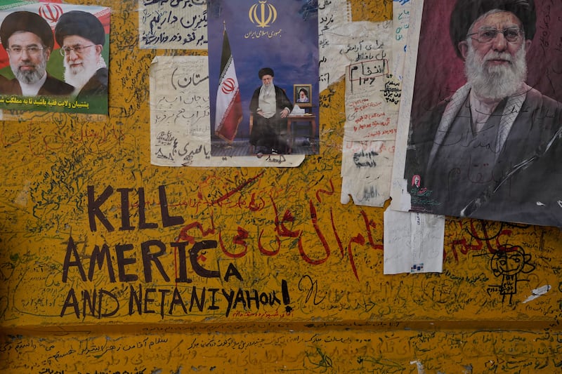 Messages are written alongside photos of the Iranian Supreme Leader Ayatollah Mojtaba Khamenei and late Supreme Leader ayatollah Ali Khamenei in Tehran. Photograph: Vahid Salemi/AP