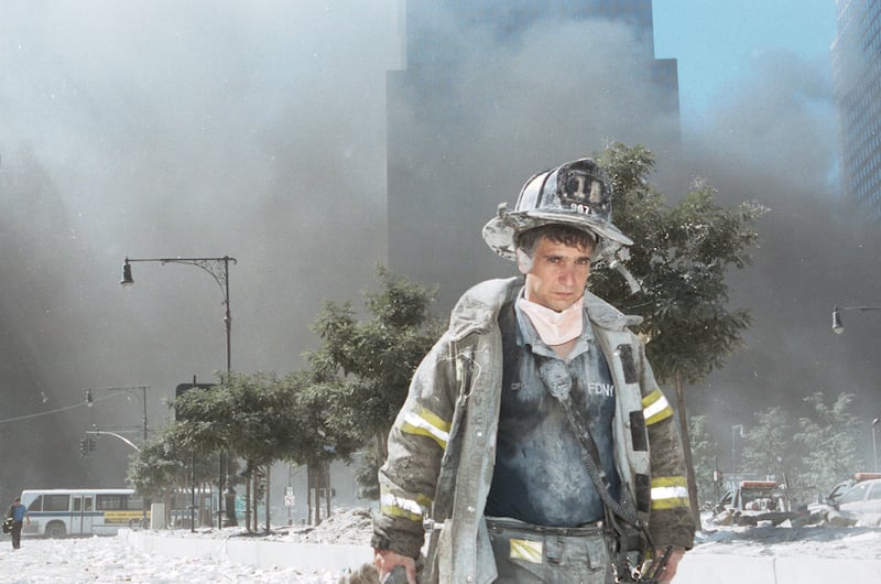An unidentified New York City firefighter walks away from Ground Zero after the collapse of the Twin Towers September 11th, 2001 in New York City. Photograph: Anthony Correia/Getty Images.