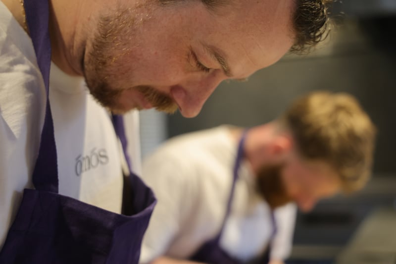 Cúán Greene,  co-owner and executive chef of Ómós, with head chef Matt Smith in the background. Photograph: Bryan O’Brien 