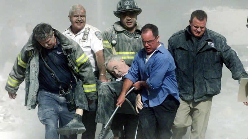 Rescue workers carry fatally injured New York City Fire Department chaplain, Fr Mychal Judge, from the wreckage of the World Trade Center in New York City on September 11th, 2001. Judge was the first official victim of the 9/11 attacks. Photograph: Shannon Stapleton/Reuters