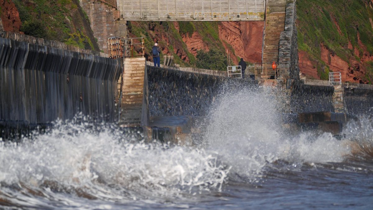 People walking along the Dawlish sea wall in Teignbridge, Devon, as weather warnings for Storm Benjamin have come into force as parts of the UK are hit by heavy downpours and strong winds. Picture date: Thursday October 23, 2025. PA Photo. Photo credit should read: Yui Mok/PA Wire