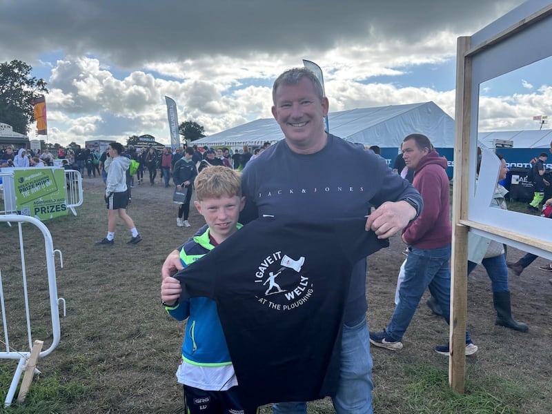 Eoghan and Shane Donlon, a father and son from Castlerea in Co Roscommon, show off their winnings from the welly throwing competition. Photo: Stephen Conneely