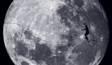 A person rides a unicycle along a tightrope with the moon behind them.