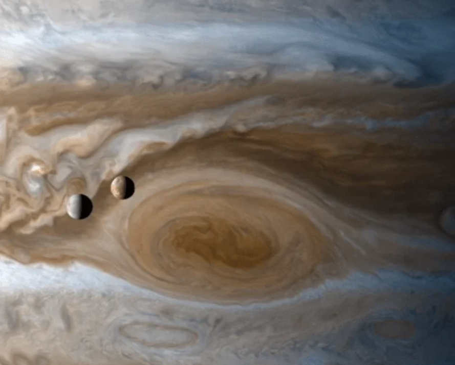 Two moons transit Jupiter during Cassini's 2000 Jupiter flyby. Credit: NASA/JPL/University of Arizona.