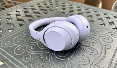 The Sony WH-1000XM4C in lavender shown lying on its side on a metal table