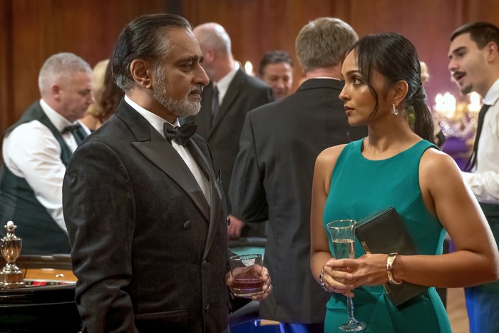 Sanjeev Bhaskar and Aysha Kala in The Split Up. Two people holding drinks and looking at one another.