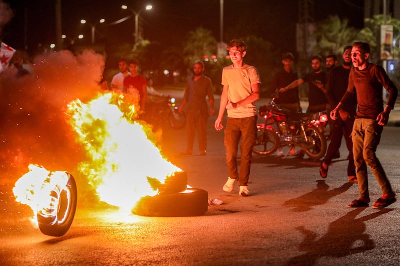 Protesters block a road with flaming tires while protesting against hikes to fuel prices in northern Syria. Photograph: Bakr Alkasem/AFP/Getty Images