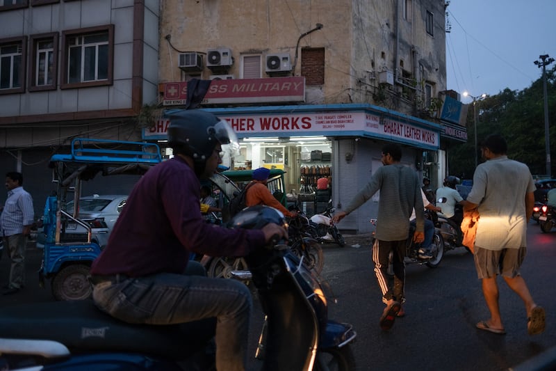 Pedestrians dodge traffic at an intersection in New Delhi. Photograph: Karan Deep Singh/The New York Times
                      