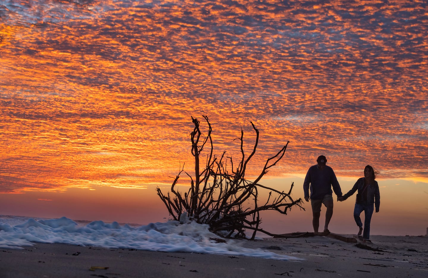 A couple stroll the beach on Nantucket at sunset on Sept. 11, 2026.
