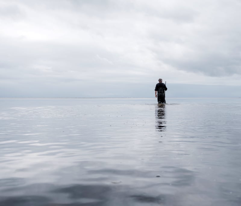 Thomas McElhone walks the shallow waters of Lough Neagh around Traad Point. Photograph: Joe Laverty