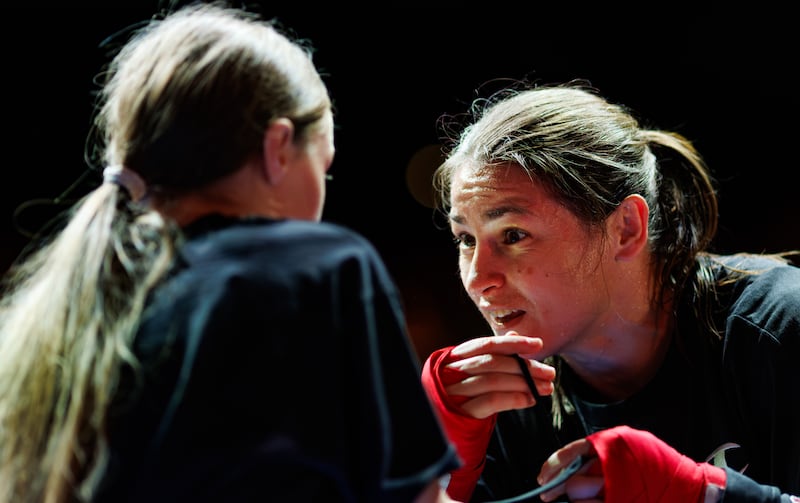 Katie Taylor gives Clodagh Keating some tips as the pair spar during Wednesday's open workout. Photograph: James Crombie/Inpho